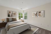 Herndon apartment for rent - A bedroom with a large bed and two paintings on the wall.
