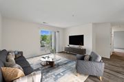 Herndon apartment for rent - A living room with a grey couch, a coffee table, and a flat screen TV.