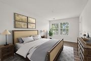 Herndon apartment for rent - A bedroom with a large bed and a wooden nightstand.