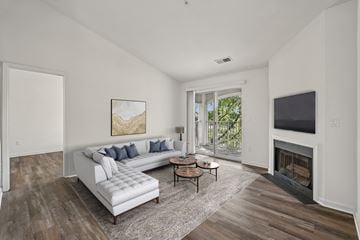 Herndon apartment for rent - A living room with a white couch and a fireplace.