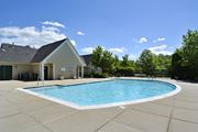Ashburn apartment for rent - A small building is behind a pool.