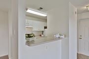 Ashburn apartment for rent - A kitchen with white cabinets and a countertop with a bowl of fruit on it.