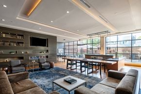 Arlington apartment for rent - A modern living room with a fireplace and a large window.