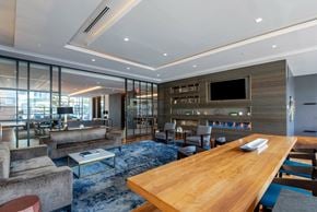 Arlington apartment for rent - A modern living room with a wooden table and a television.