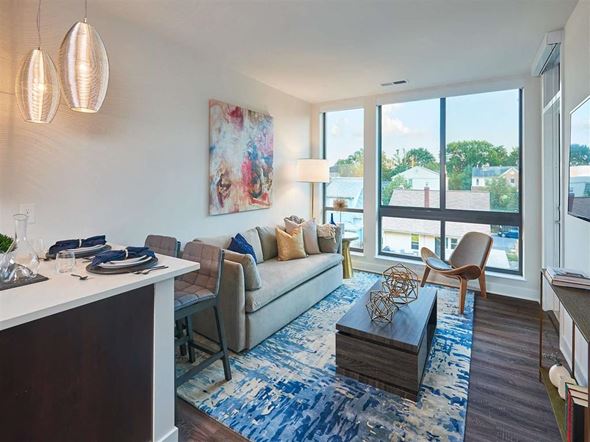 Arlington apartment for rent - A modern living room with a large window and a painting on the wall.