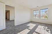 Ashburn apartment for rent - A room with a carpet and a window overlooking a city.