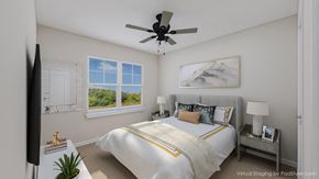 Charlestown apartment for rent - A bedroom with a large bed and a ceiling fan.