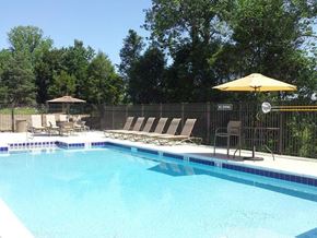 Charlestown apartment for rent - a swimming pool with chairs and an umbrella