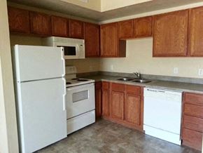 Taylorsville apartment for rent - a kitchen with white appliances and wooden cabinets