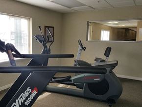 Taylorsville apartment for rent - a gym with a treadmill and a mirror