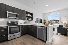 Danvers apartment for rent - A modern kitchen with dark wood cabinets and stainless steel appliances.