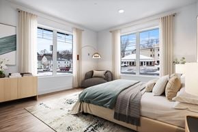 Danvers apartment for rent - A bedroom with a large bed and a view of the street outside.