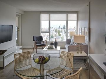 Vancouver apartment for rent - A living room with a glass table and chairs.