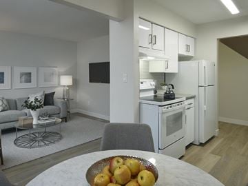 Vancouver apartment for rent - A kitchen with white appliances and a grey chair.
