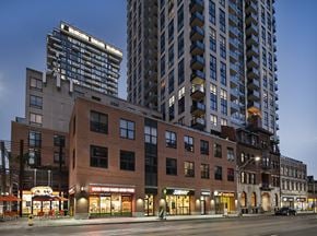 Toronto apartment for rent - A city street with a building that has a sign that says "Good Food Market".