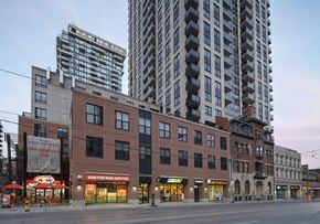 Toronto apartment for rent - A city street with a building that has a sign that says "We applaud you".