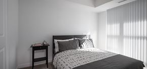 Toronto apartment for rent - A bedroom with a bed, nightstand, and window with blinds.