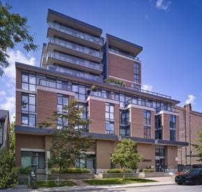 Toronto apartment for rent - A modern multi-story building with balconies and large windows.