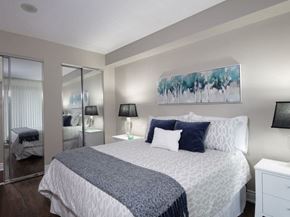 North York apartment for rent - a bedroom with a bed and a mirror