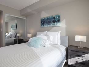 Toronto apartment for rent - a bedroom with a large bed and a mirror