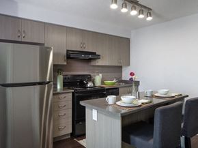 Toronto apartment for rent - a kitchen with a refrigerator freezer next to a stove top oven