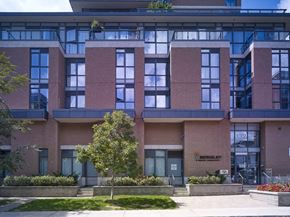 Toronto apartment for rent - a brick building with a tree in front of it