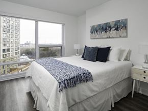 Etobicoke apartment for rent - a bedroom with a large bed and a large window