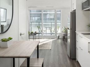 Etobicoke apartment for rent - a kitchen and dining room with a large window