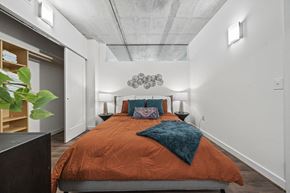 Richmond apartment for rent - a bedroom with a bed and a closet at The Icon, Richmond, VA 23230