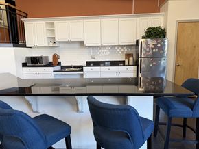 Richmond apartment for rent - A kitchen with a refrigerator, two chairs and a table.