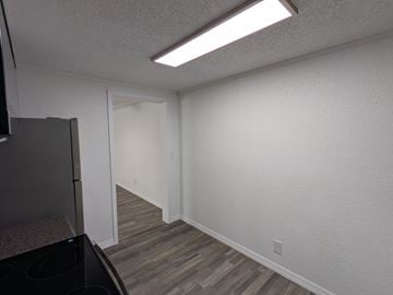 Cocoa apartment for rent - A kitchen with a black stove top oven and a white wall.