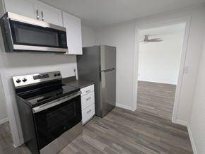 Cocoa apartment for rent - A kitchen with a stove, oven, microwave, and refrigerator.