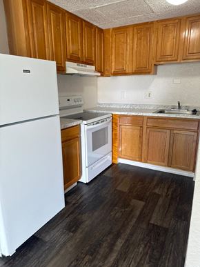 Orlando apartment for rent - a kitchen with white appliances and wooden cabinets
