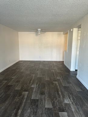 Orlando apartment for rent - an empty living room with wood floors and a ceiling fan