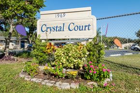 Lakeland apartment for rent - A sign that says Crystal Court in front of a fence.