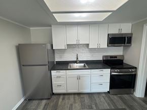 Titusville apartment for rent - A kitchen with a refrigerator, sink, and oven.