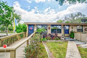 Tampa apartment for rent - the front of a house with a porch and a walkway