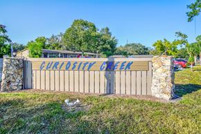Tampa apartment for rent - a sign that reads chicken creek in front of a fence