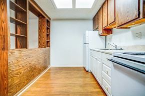 Tampa apartment for rent - a kitchen with white appliances and wooden cabinets