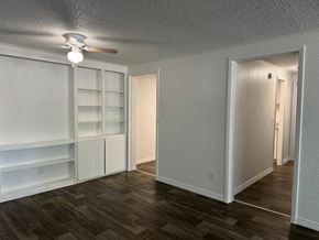 Lakeland apartment for rent - a living room with white shelves and a ceiling fan