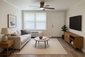 Titusville apartment for rent - A living room with a couch, a coffee table, a side table, a television, and a plant.
