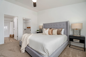 Clayton apartment for rent - A bedroom with a large bed and a ceiling fan.