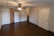 Roanoke apartment for rent - A room with a ceiling fan and wooden floors.