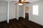 Roanoke apartment for rent - A room with a ceiling fan and wooden floors.