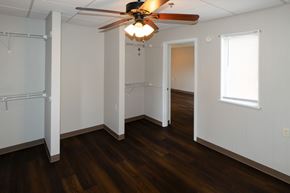 Roanoke apartment for rent - A room with a ceiling fan and wooden floors.