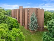 Roanoke apartment for rent - A large brown building with a tree in front of it.