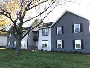 Westerville apartment for rent - a gray house with a large tree in front of it
