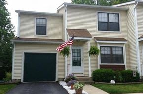 Worthington townhouse for rent - a yellow house with an flag in front of it