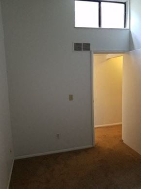 Westerville triplex for rent - an empty room with an open door and a window