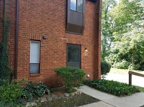 Westerville triplex for rent - a brick building with a black door and a sidewalk